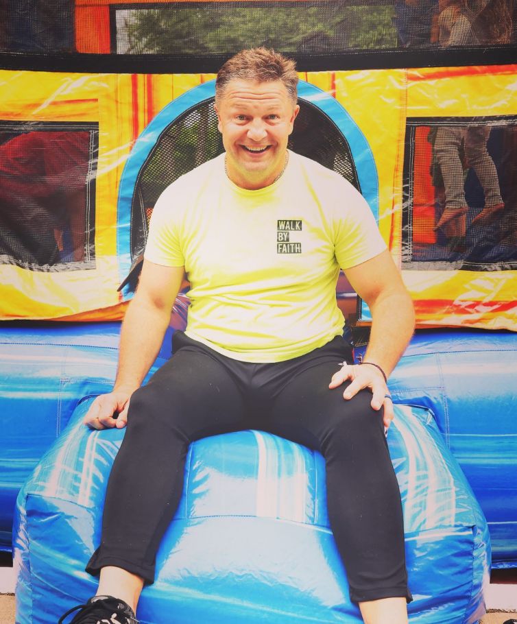 Dr. Hooten sitting on a bounce house